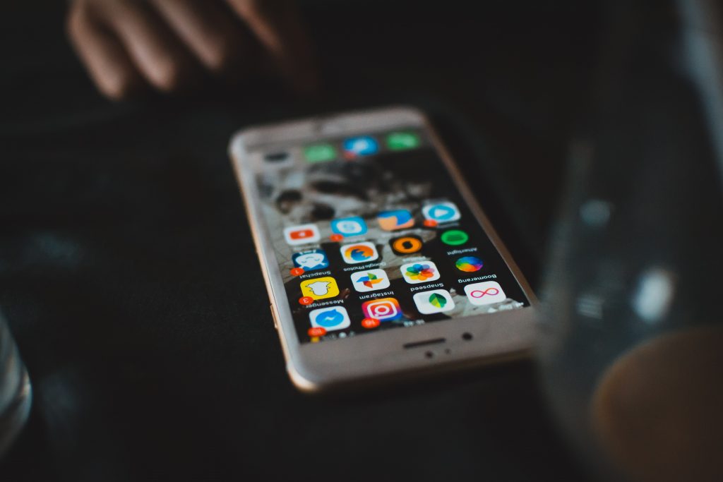 Phone with social media icons including instagram