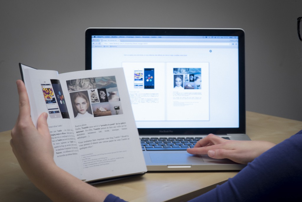 an open blog book in front of an open computer 